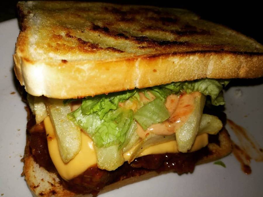 Loaded toasted sandwich with chips, cheese and lettuce